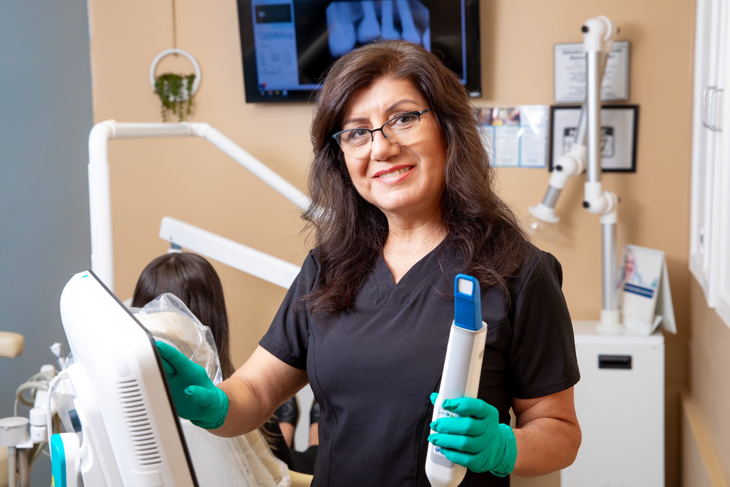 Confident Patient Smiling and Forming a Heart Gesture in a Modern Dental Office – Dentist in Riverside CA